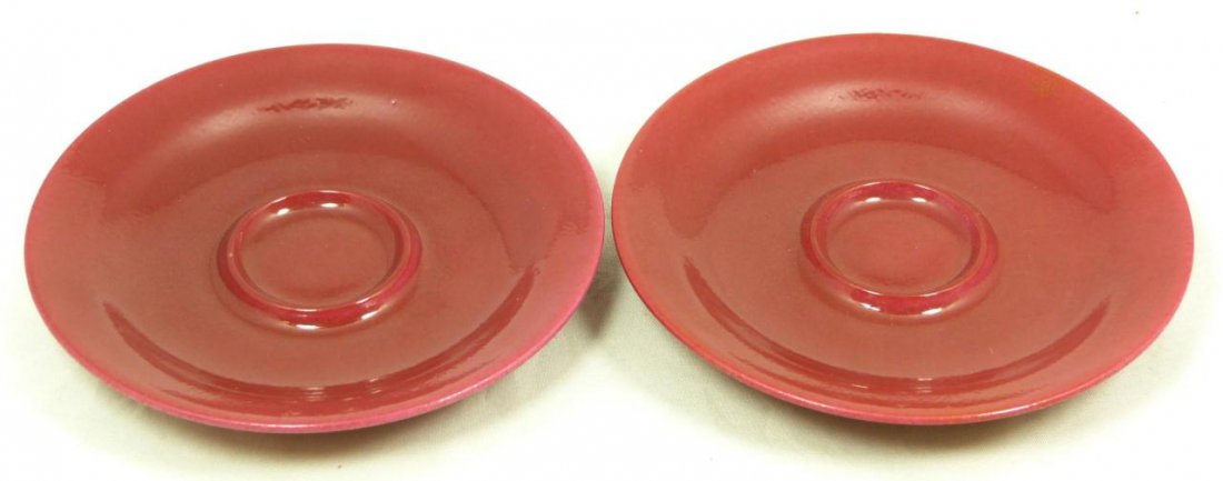 Pr OF 18th C CHINESE RED GLAZE TEA CUP SAUCERS: Pair of antique Chinese Qing Dynasty red glaze porcelain tea cup saucers. Each holds six character blue calligraphy Yongzheng (1723-1735) reign marks in double bands to bottom, and are made of the per
