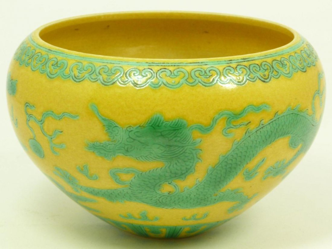 18th C CHINESE YELLOW AND GREEN DRAGON BOWL: Antique Chinese Qing Dynasty period dragon bowl having hand painted enameled Green dragons with jewels amongst clouds and lingzhi border rim over yellow ground. Bottom holds impressed six character ar