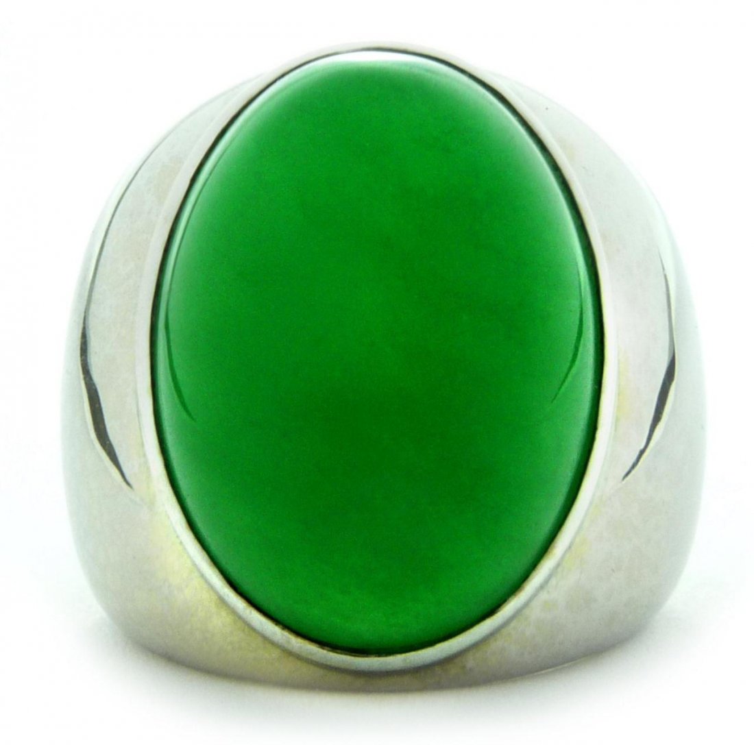 18K WG & EMERALD GREEN NATURAL A JADEITE RING: A massive and stunning gent's 18k white gold ring mount holding an emerald green oval cabochon cut jadeite stone. Glowing translucent emerald green color to jadeite stone. Stone measures approx. 25.4m
