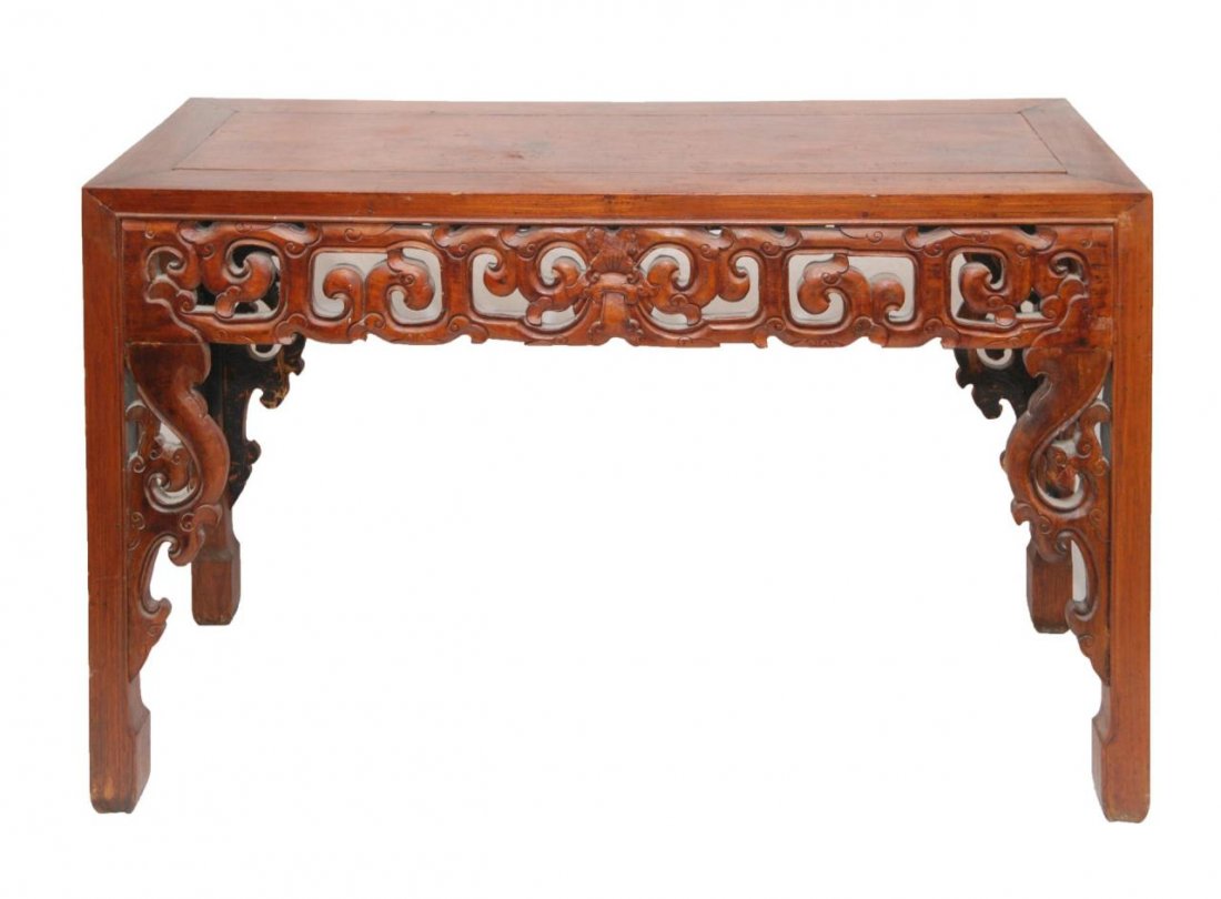 CHINESE HUANGHUALI WOOD ALTAR TABLE: Chinese carved Huanghuali wooden altar table having archaic scrolled design throughout. 19th/20th century. Measures 32" height x 55" length x 21 1/2" depth (81.2cm x 139.7cm x 54.6cm).