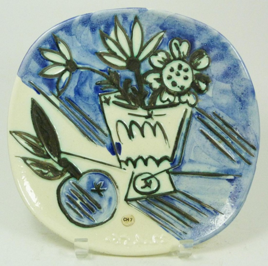 PICASSO ATELIER MADOURA FRENCH CERAMIC PLATE: Picasso Atelier Madoura France ceramic plate depicting a still life with flower pot and fruit. Verso holding impressed Madoura marks. Measure 9 3/4" diameter (24.7cm).