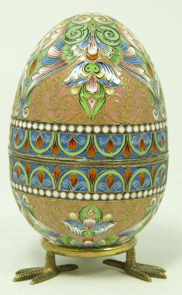 RUSSIAN SILVER ENAMELED EGG BOX w STAND: Russian silver enameled egg box having multicolor scrolled floral design and peach ground. Gold wash interior. Includes stand with three figural eagle's feet. Piece holds Fedor Ruckert workmaster mark