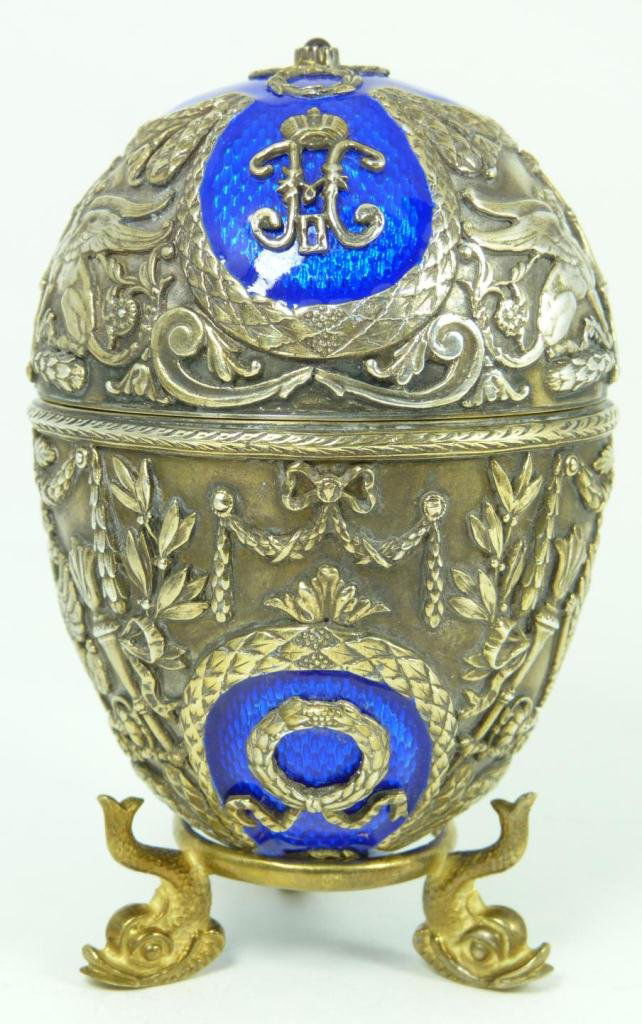 RUSSIAN SILVER & ENAMEL EGG: Incredible Russian silver & cobalt enamel egg. Has intricate raised design depicting the Russian double headed eagle, torches, wreaths and griffins with crest of Nicholas II. Mounted with Cabochon gar