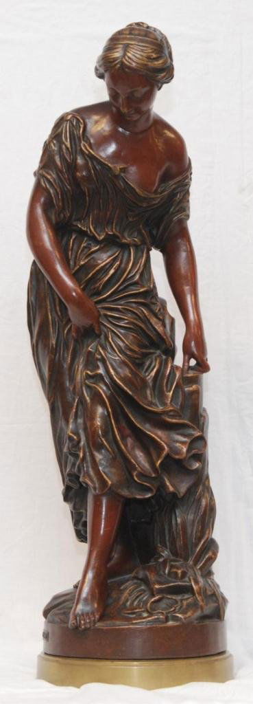 VAL D'OSNE FOUNDRY BRONZE SCULPTURE OF WOMAN: A large Du Val D'Osne Foundry bronze sculpture depicting a standing woman in layered robe. Brown patina throughout. Has gilded brass base. Plaque to bronze base with 'Val D'osne' foundry mark. Measure