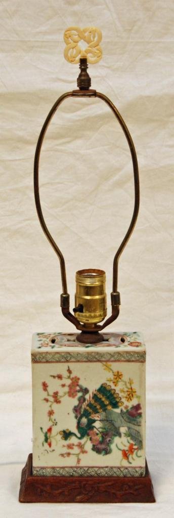 CHINESE PORCELAIN INCENSE BURNER LAMP: Antique Chinese hand painted enameled porcelain lamp depicting two peacocks and flowering dogwood branches. Has fitted wooden base. Has interlocking snakes knot carved bone finial. Incense burner not 