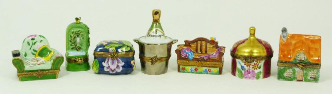 LOT OF 7 FRENCH LIMOGES TRINKET BOXES: Lot of seven hand painted figural Limoges French porcelain trinket boxes. Includes spigot, settee, chair with remote, house, champagne bottle in bucket and two floral boxes. Tallest measures 3 1/8" he
