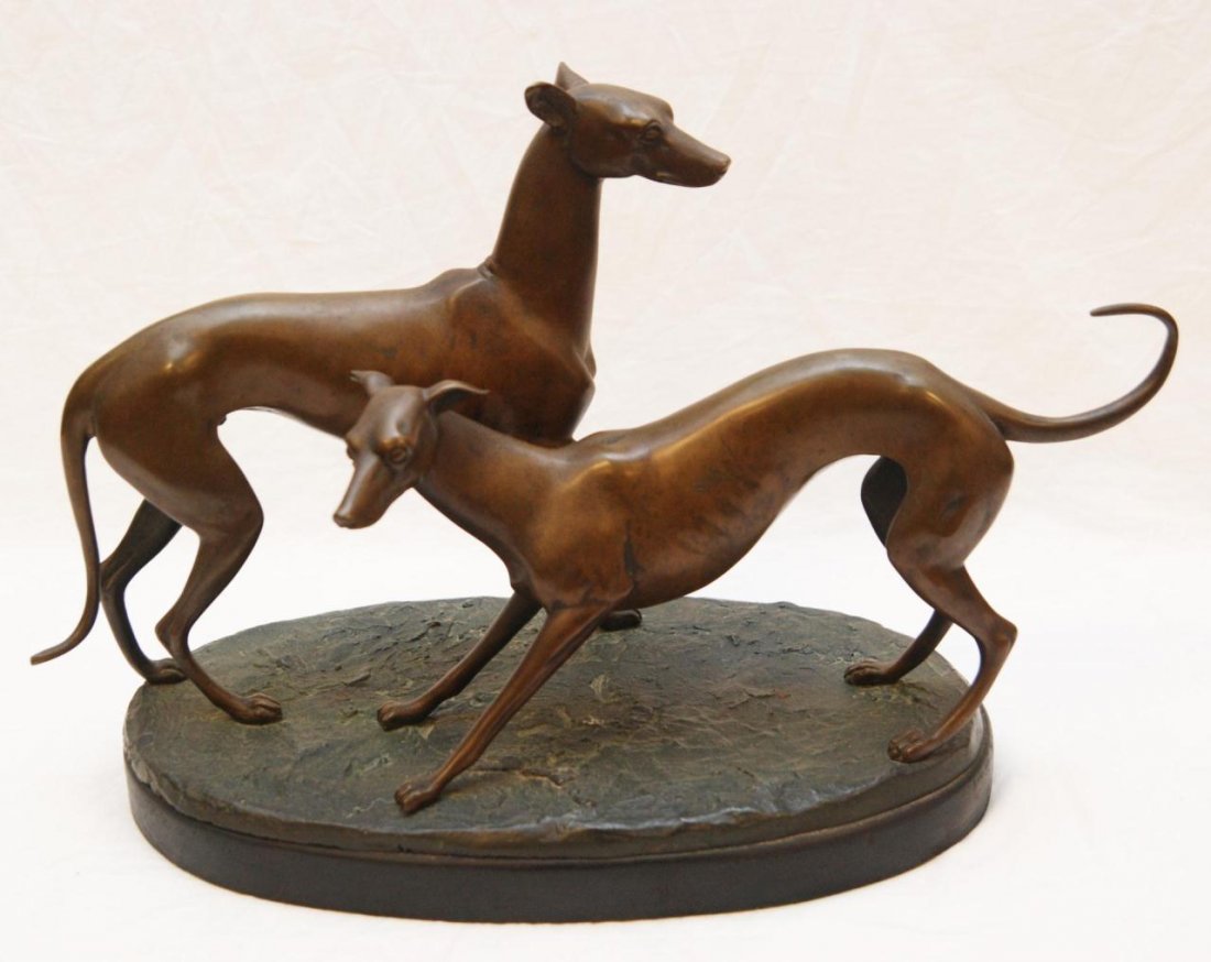 HOFFMAN BRONZE GROUP SCULPTURE OF WHIPPETS: Hoffman bronze group figure depicting two whippets on earth form base. Signed 'Hoffman' to base. Attributed to Malvina Hoffman (AMERICAN, 1887-1966). Measures 12" height x 17" length (30.4cm x 43.1cm)
