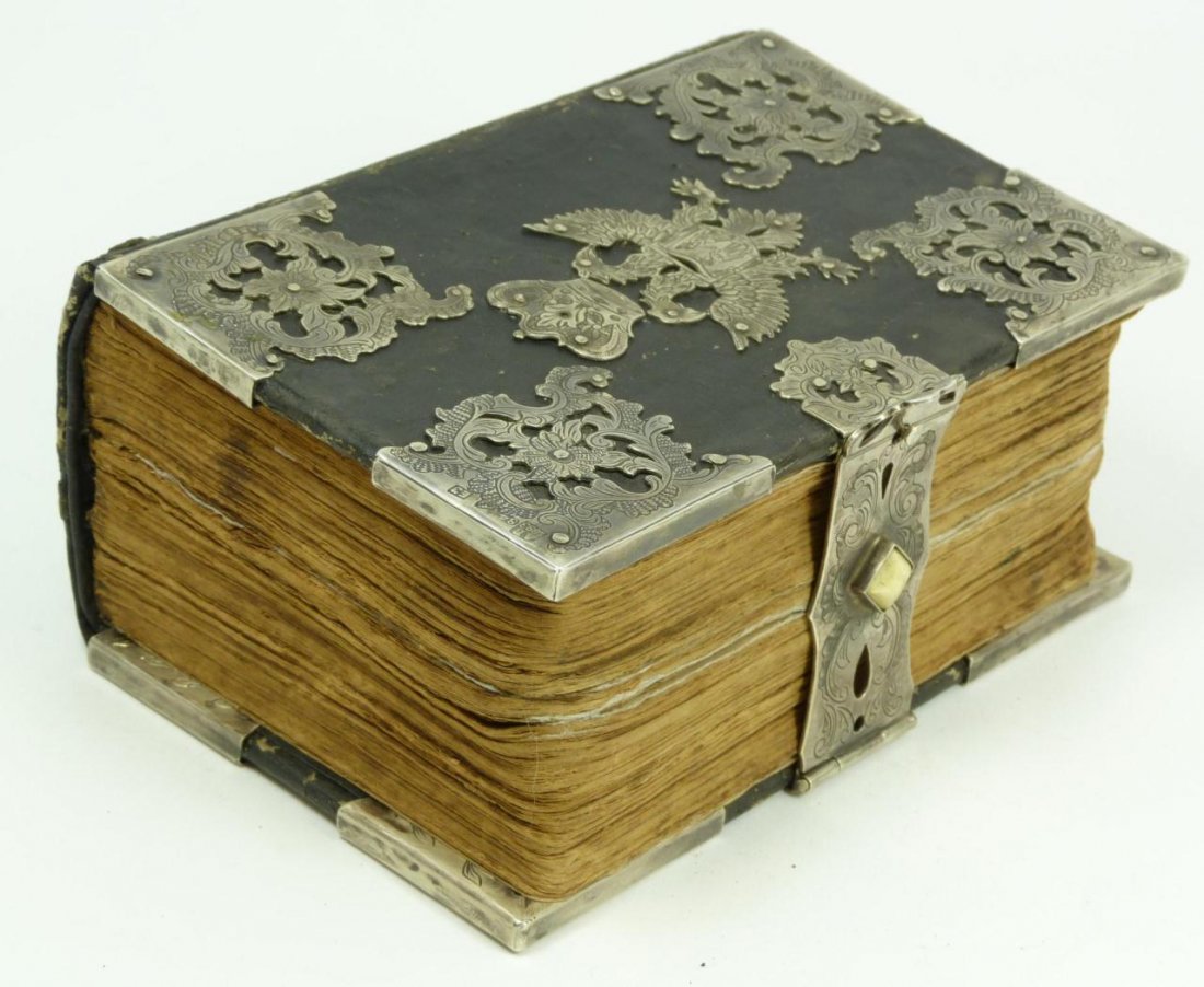 ANTIQUE RUSSIAN SILVER CLAD JUDAICA BOOK: 19th century Judaica book clad with Russian silver throughout. Has floral scrolled designs throughout with double headed eagle under crown. Has silver clasp with ivory bead. Holds AB 1897 assayer's ma