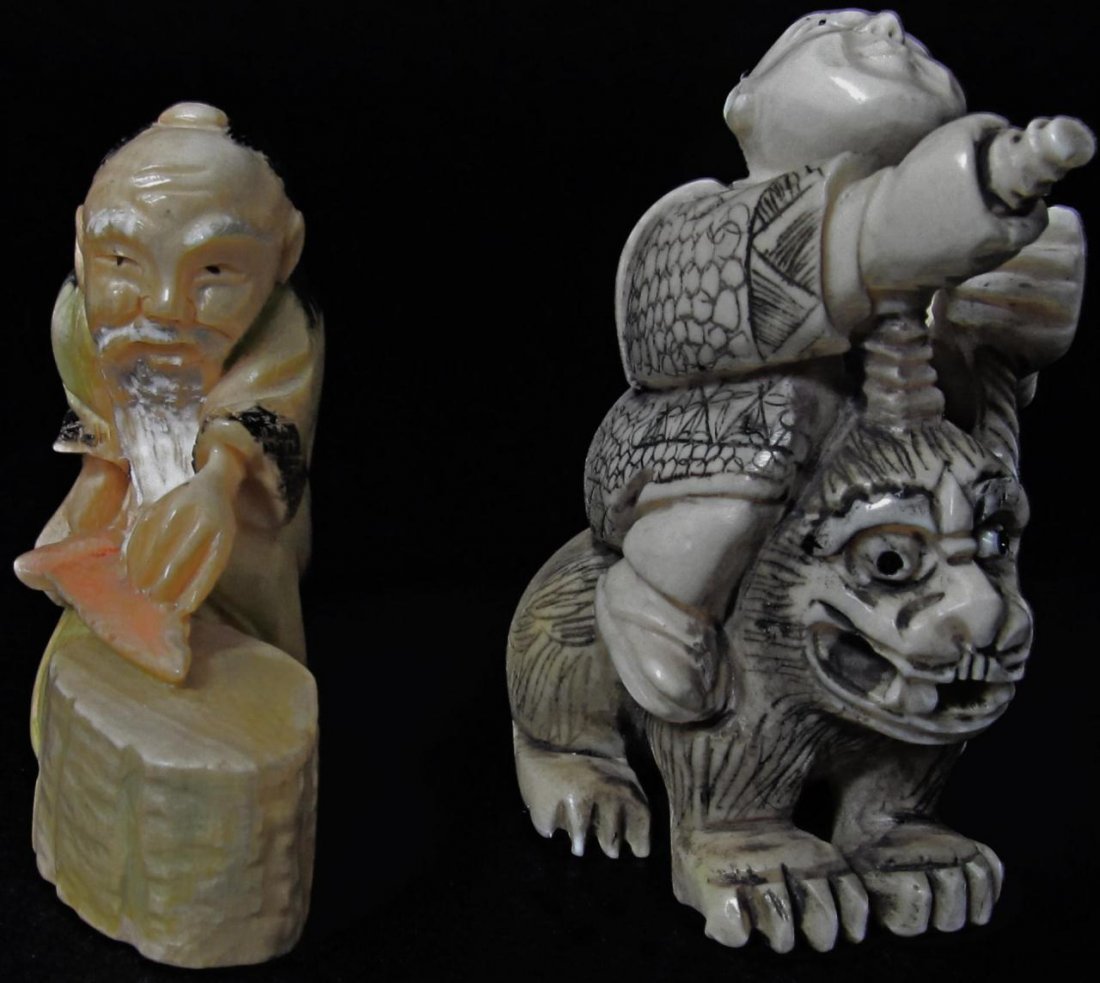 2 JAPANESE CARVED IVORY STUDY & NETSUKE: Lot of 2 carved Japanese ivory figures. Includes a study depicting a blacksmith working on a sword and netsuke depicting a man riding on the back of a foo dog. Largest measures 2" height (5.1cm). Tota