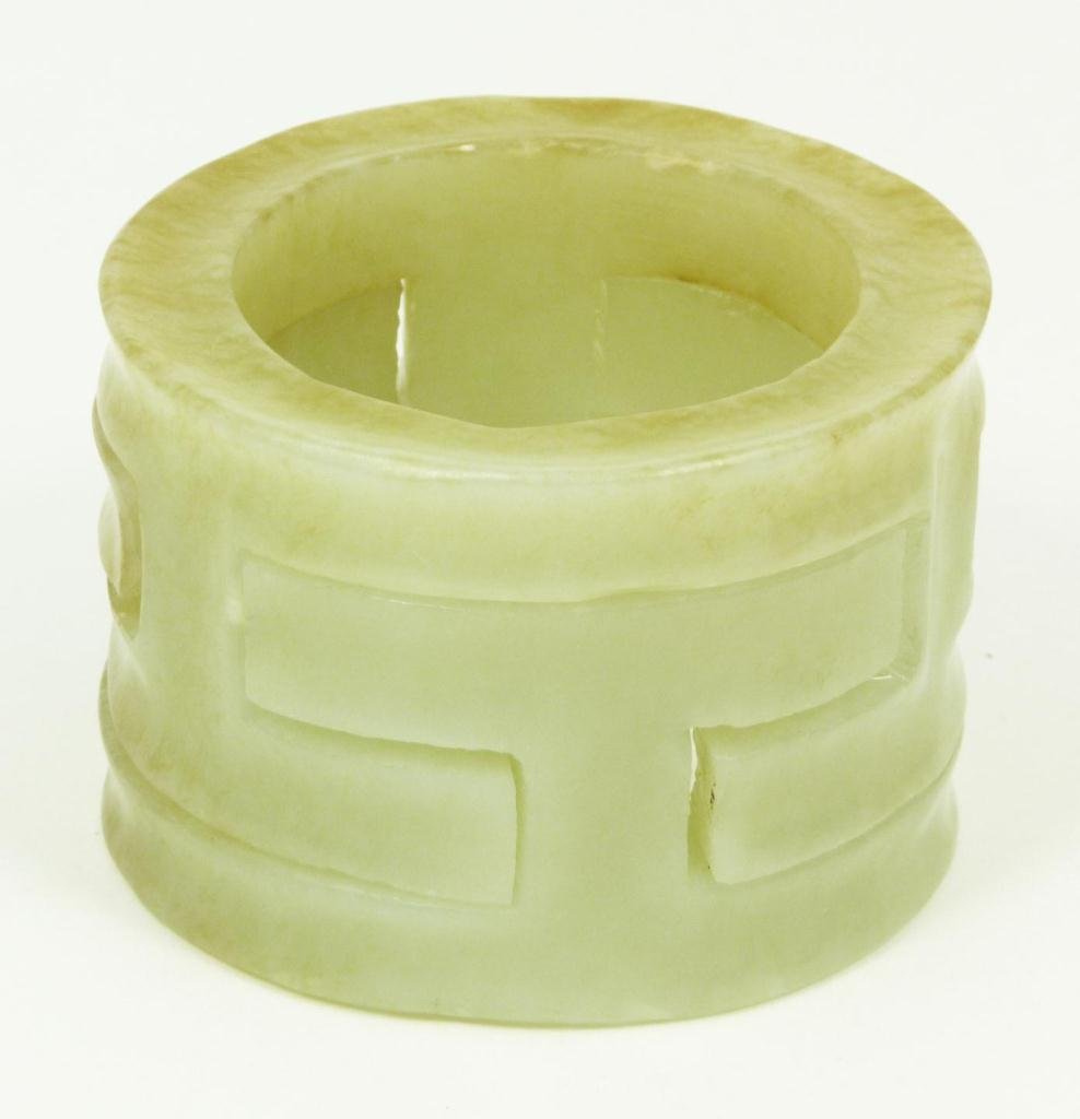 CHINESE CARVED CELADON JADE PUZZLE RING: 2 piece Chinese hand carved celadon jade ring with a puzzle design. Glowing translucent even toned jade with some russet pebbling. 19th century. Measures 1 1/2" height x 2 1/4" diameter (3.8cm x 5.7cm
