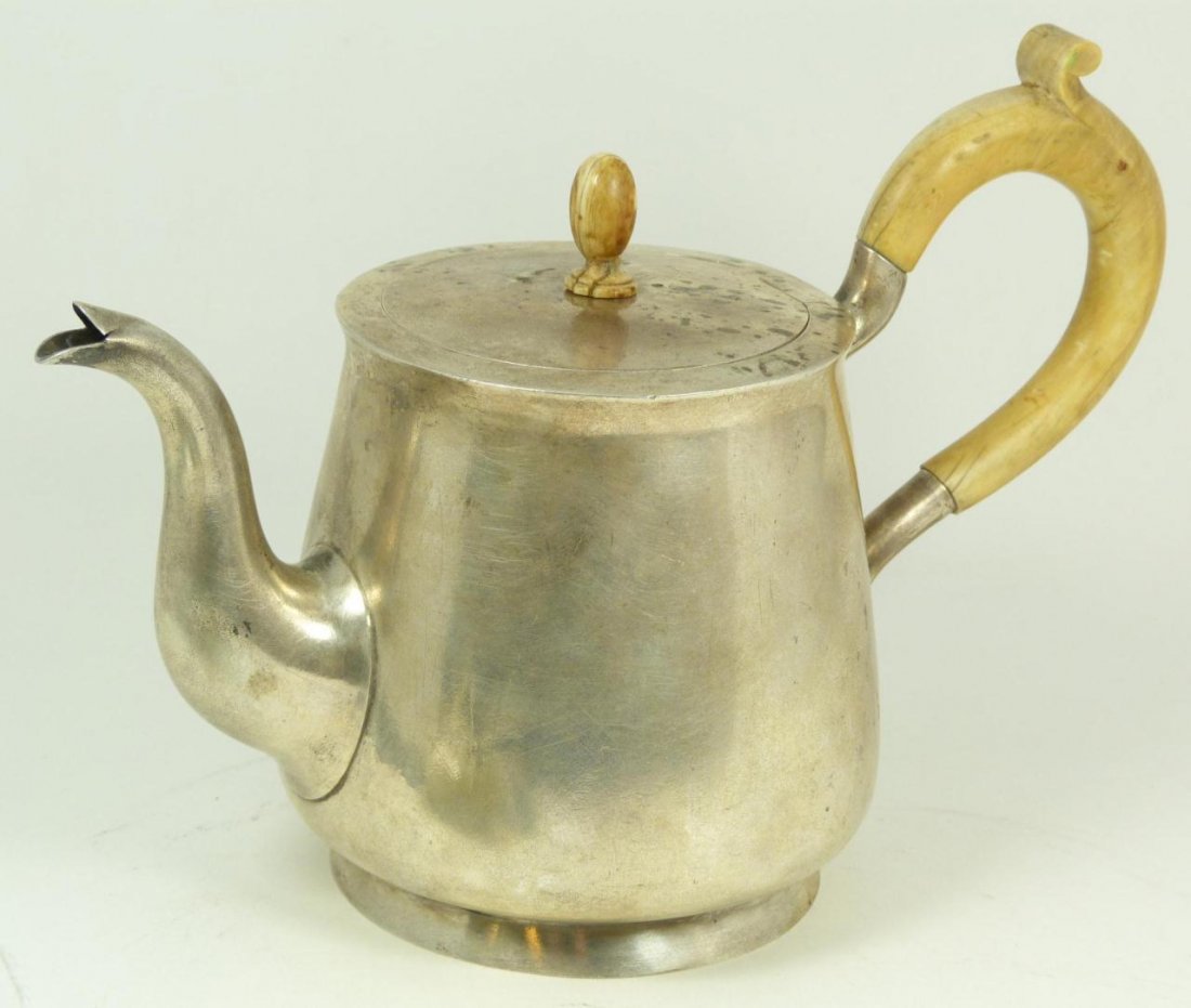 RUSSIAN SILVER TEA POT WITH CARVED IVORY HANDLE: Russian silver tea pot with a carved ivory handle. Holds A-K 1880 assayer marks with 84 silver purity marks. Holds AA workmaster marks to rim, most likely Andreì Andreev. Also holds Cyrillic marks fl