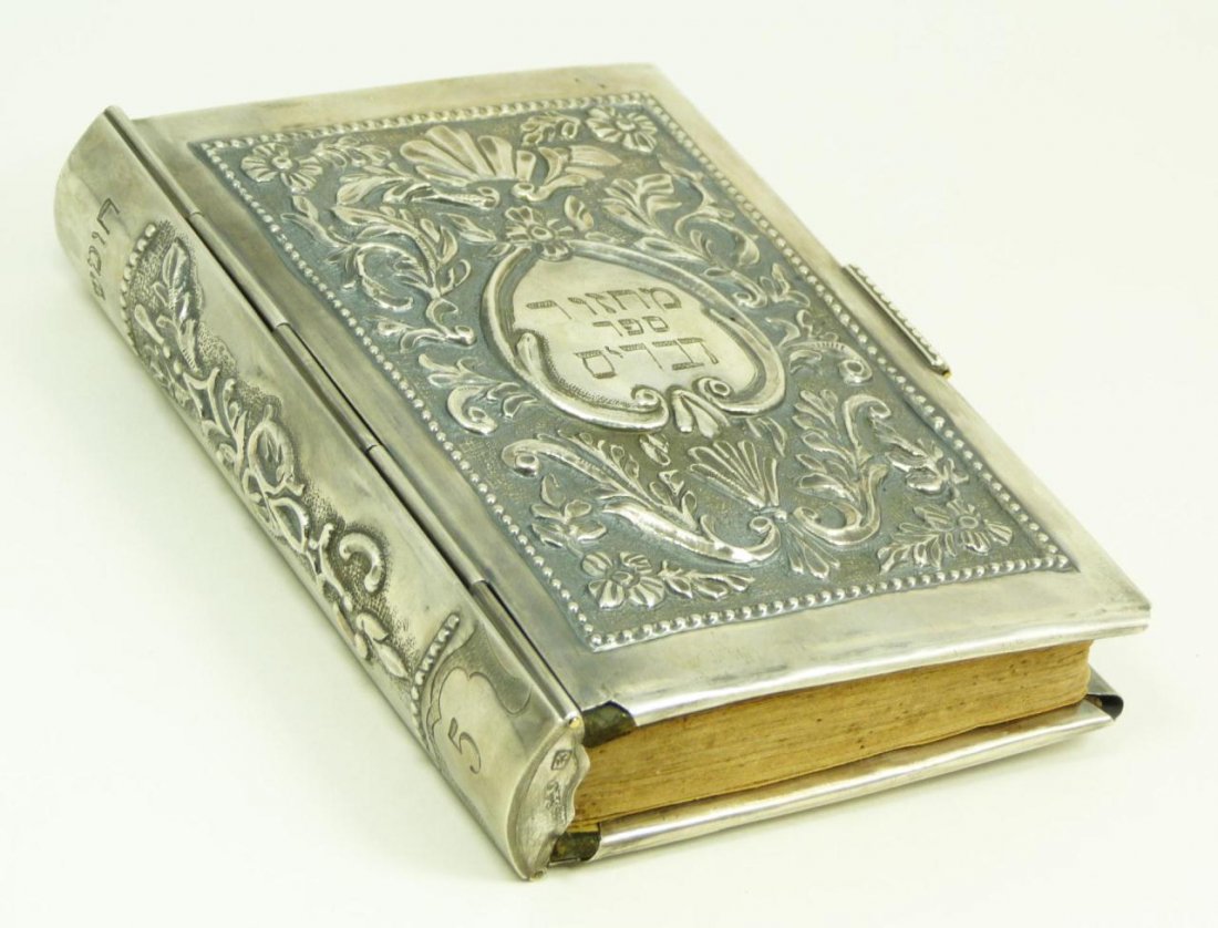 RUSSIAN SILVER COVERED JUDAICA PRAYER BOOK: Russian silver repousse covered Judaica prayer book cover. Has raised scrolled floral design on front and back. Holds impressed 1895 Alexander Kazmirovich Vyrzhikovsky assayer marks and Minsk town mar