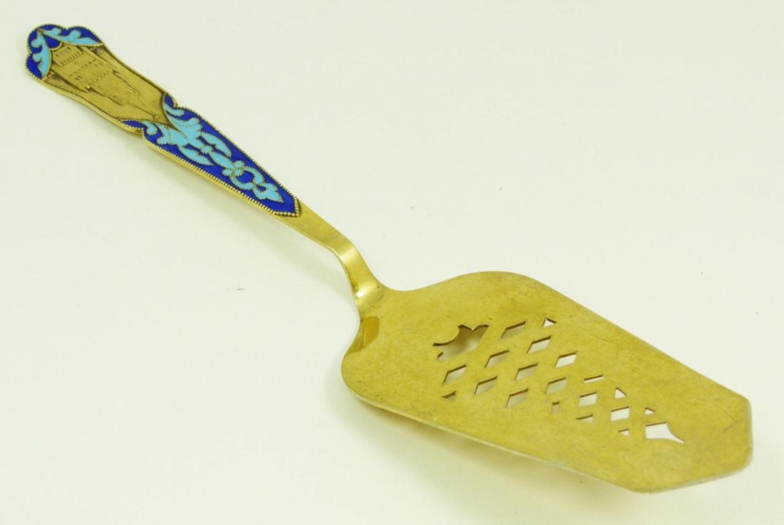 SOVIET 875 SILVER ENAMELED CAKE SERVER: Russian Soviet Silver enameled cake server with a raised castle design over a two tone blue enameled design on handle. Also has gold wash throughout. Holds 875 silver marks with maker's marks. Measure