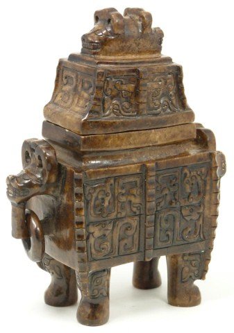 CHINESE HAN DYNASTY STYLE CARVED JADE DING VESSEL: Antique Chinese Han Dynasty style carved jade ding vessel intricately carved with raised archaic dragons and beast mask design throughout. Has figural horned beast handles on each side with relief car