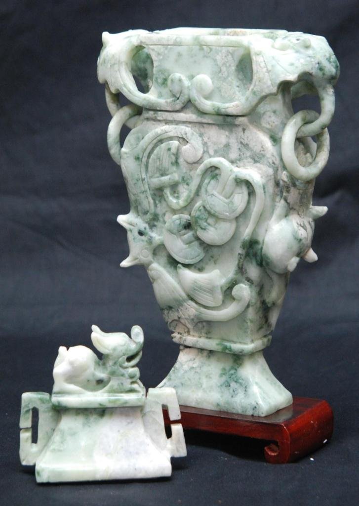 CHINESE CARVED SOAPSTONE LONG LIFE VESSEL: Chinese fully relief carved soapstone long life vessel with high relief design depicting bats with coins. Cover has figural foo dog finial. Includes wooden base. 19th/20th century. Measures 12 1/2" he