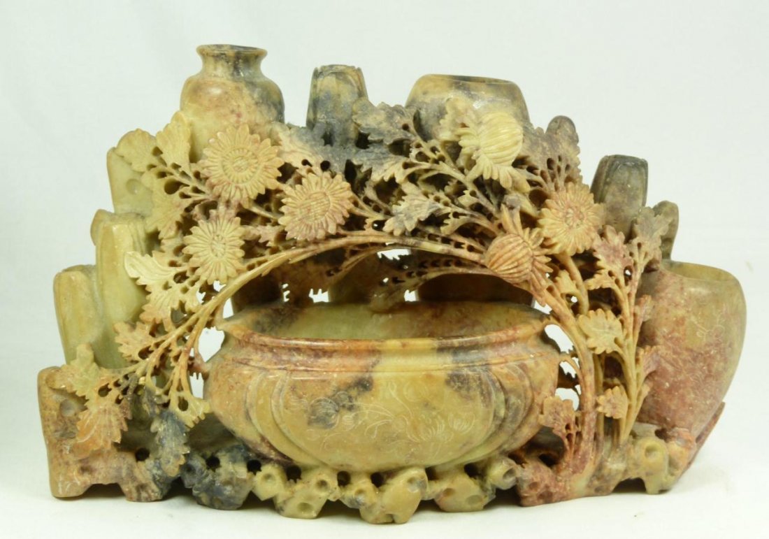 CHINESE RELIEF CARVED SOAPSTONE PLANTER: Chinese relief carved soapstone planter depicting flowers and rock formations. Intricately carved throughout. 19th/20th century. Measures 6 5/8" height x 10 3/4" width (16.8cm x 27.3cm). Total weight 