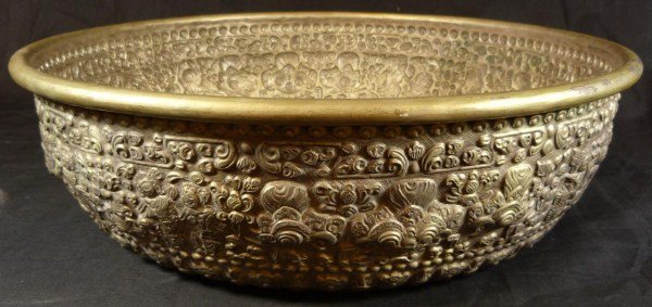 HAND CRAFTED BALINESE SILVERPLATE OFFERING BOWL: Repousse silver plate Balinese offering bowl. Has intricate pattern depicting mythological beasts and figures with scrolled floral design. Circa 1920. Measures 4 3/4" height x 16 1/4" diameter (12cm x