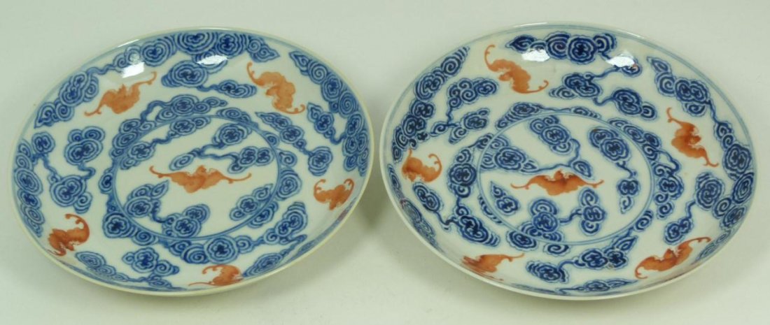 PAIR OF CHINESE PORCELAIN LONG LIFE DISHES: Pair of Chinese hand painted enameled porcelain long life dishes, each depicting red bats amongst clouds. Bottoms hold six character blue calligraphy marks in double circles. Each measures approx.7 1/