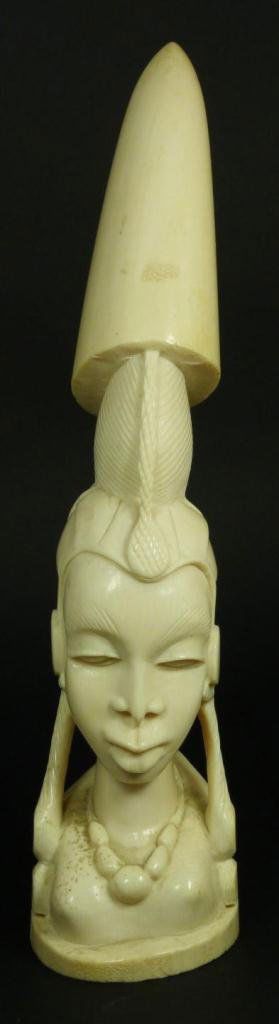AFRICAN RELIEF CARVED IVORY BUST OF FEMALE: African relief carved ivory tusk depicting the bust of a tribal female. Measures 13 1/4" height (33.6cm). Total ivory weight of 1552 grams.