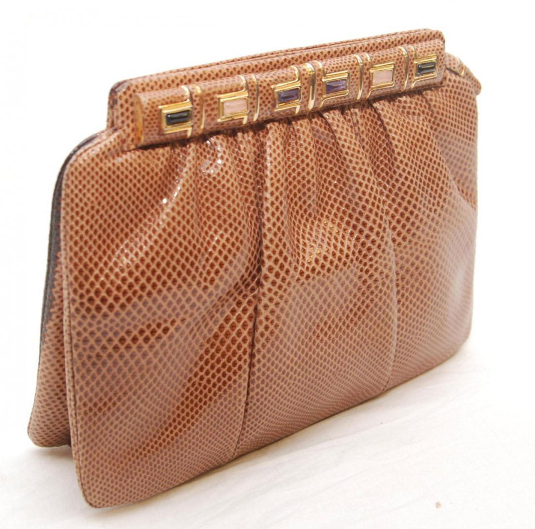 JUDITH LEIBER SNAKESKIN LEATHER HANDBAG: Judith Leiber brown snakeskin leather handbag. Has brown fabric interior with two pockets. Gold hardware with rectangular cut stones. Includes dust cover bag. Measures 7" height x 9" width x 3" depth