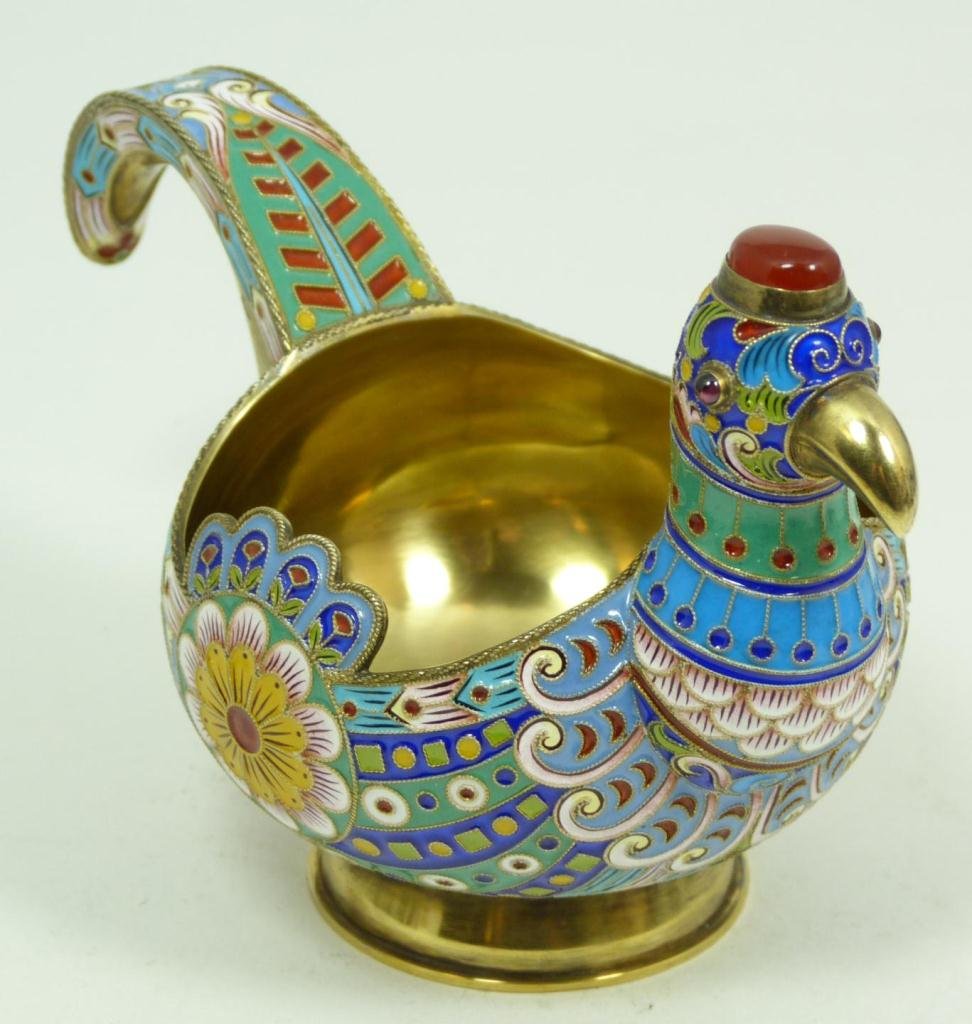 RUSSIAN SILVER AND ENAMEL FIGURAL EAGLE KOVSH: Russian silver enameled Kovsh having scrolled floral design throughout with figural eagle head design. Has cabochon cut rubies set to eyes and carnelian set to top of head. Gold wash interior. Holds C