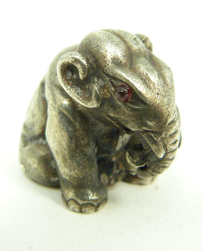 RUSSIAN SILVER SEATED ELEPHANT FIGURE: Russian silver seated elephant figure having cabochon cut ruby jewels set to eyes. Holds town, 84 silver purity and Julius Rappaport workmaster marks. Measures 3/4" height (1.9cm). Total weight of .64