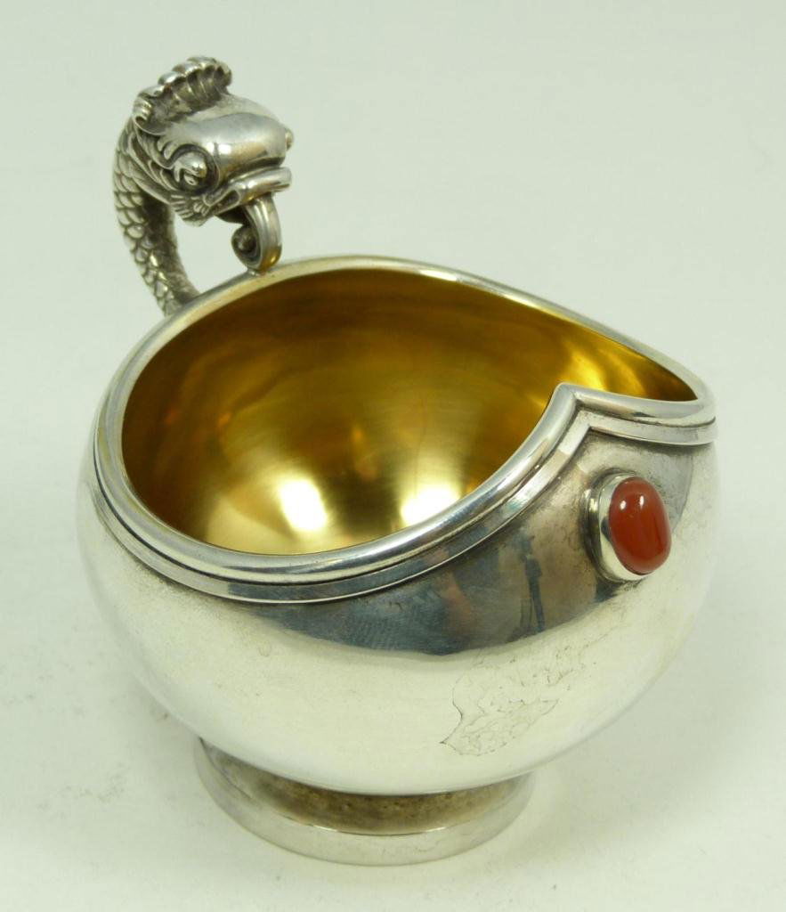 RUSSIAN SILVER KOVSH WITH CABOCHON STONE: Russian silver Kovsh. Handle has figural fish design. Oval Cabochon carnelian stone bezel set to front of vessel. Gold wash interior. Holds Julius Rappaport workmaster, 88 silver purity, St. Petersbur