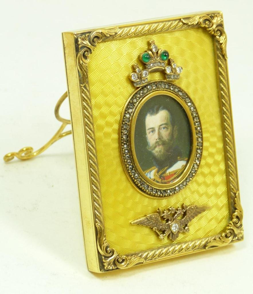 RUSSIAN SILVER GUILLOCHE ENAMELED PICTURE FRAME: Russian silver yellow guilloche enameled picture frame having cabochon emerald and diamond jeweled crown and double headed eagle design. Has oval border design to center with the portrait of Nicholas 