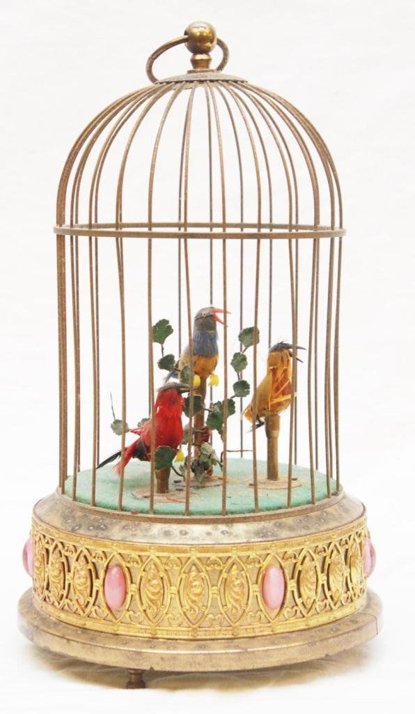OLD GERMAN SINGING BIRD MUSIC BOX: Old German singing bird music box having three birds to interior. Oval pink stones applied to exterior. Measures 12 1/4" height (31.1cm). Total weight of 1141 grams.