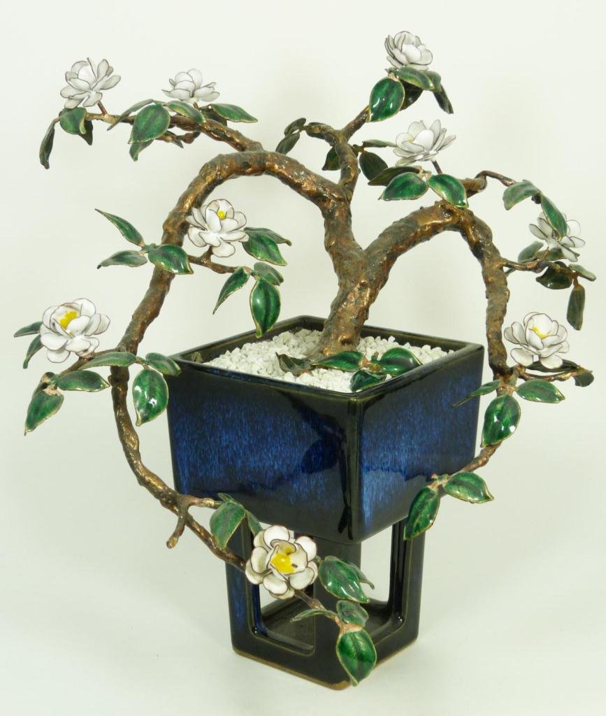JAPANESE ENAMEL ON COPPER FLORAL IN FLAMBE POT: Otagiri Japanese enamel on copper floral sculpture having a footed blue flambe pottery pot. 20th century. Measures 13 1/2" height x 15" width (34.2cm x 38.1cm). Total weight of 3292 grams.