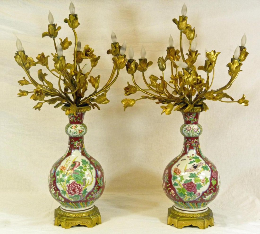 PAIR OF CHINESE PORCELAIN & DORE BRONZE LAMPS: Pair of old Chinese porcelain vases with hand painted floral designs and paradise birds. Each vase is mounted as a lamp with Gilded French metal flower and leaf design. Wreath design on base. Each mea