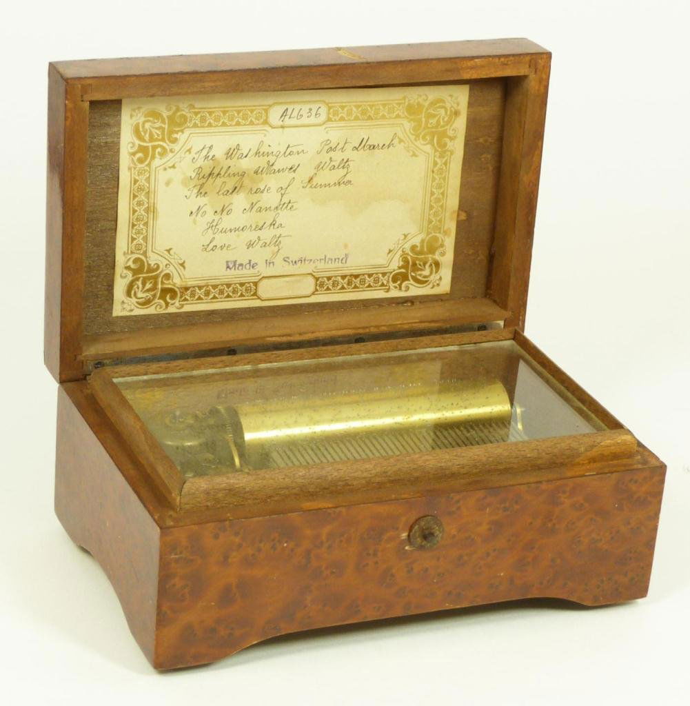THORENS SWISS MUSIC BOX: Old Thorens New York burlwood hinged Swiss music box. Numbered AL636. Has 6 songs including 'The Washington Post March', 'Rippling Waves Waltz', 'The Last Rose of Summer', 'No No Nanette', 'Humoreska'