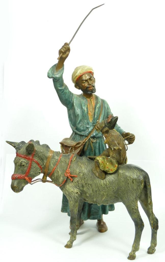 AUSTRIAN COLD PAINTED BRONZE OF AN ARAB w DONKEY: Austrian cold painted bronze sculpture depicting a standing Bedouin with donkey. A monkey can be seen riding on the back of the donkey. Circa 1920. Measures 9 7/8" height x 7" width (25cm x 17.8cm). T