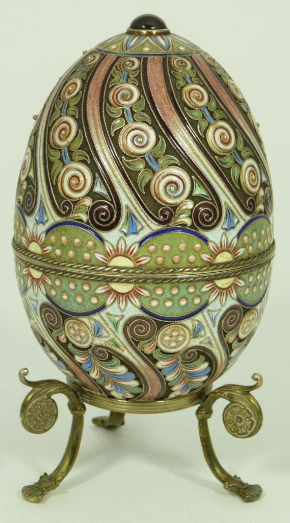 RUSSIAN SILVER ENAMELED AND JEWELED EGG BOX: Russian silver egg box with a multicolor enameled spiral design. Round cabochon ruby set on top. Gold wash interior. Holds double headed eagle mark, 84 silver purity with Moscow Kokoshnik town mark an