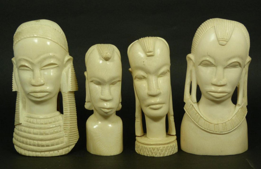 FOUR AFRICAN HAND CARVED IVORY BUSTS & PLAQUES: A lot of 4 African hand carved ivory items including 2 busts and a pair of wall plaques depicting tribal boys and girls. Largest measures approx. 7" height (17.8cm). Total weight of 2178 grams.