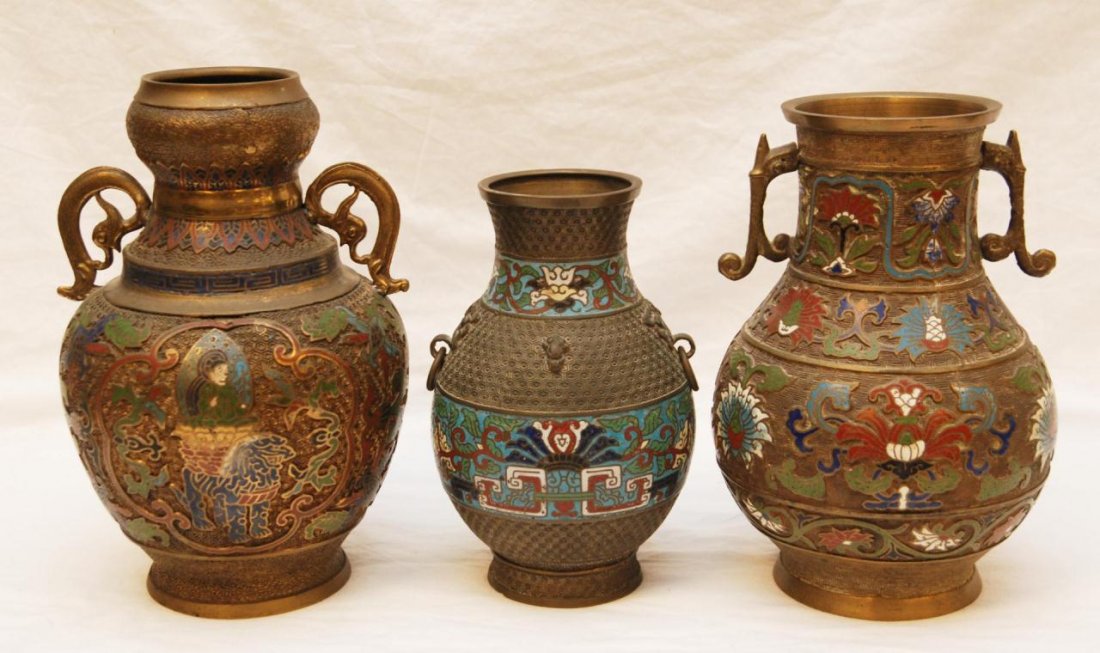 LOT OF THREE JAPANESE ENAMELED CHAMPLEVE VASES: A lot of 3 Chinese Champleve vases. The two larger have a gilded metal design with lotus blossoms and the other i constructed of bronze with lotus blossoms and scrolled vines. 19th/20th century. Talle