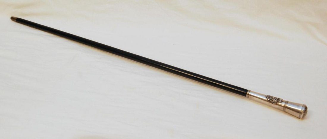 RUSSIAN SILVER KIDDUSH CUP & DAGGER CANE: A Russian silver cane holding a hidden fitted Polish silver kiddush cup in handle. Front of silver handle has applique double headed eagle coat of arms design. Handle can be pulled from shaft and a da