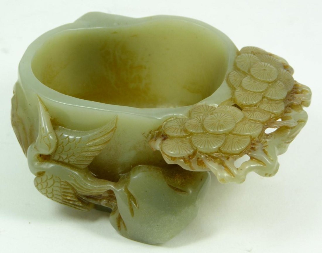 CHINESE CARVED JADE SCHOLAR'S WATER COUPE: A Chinese hand carved jade crane and pine tree scholar's desk water coupe. 19th/20th century. Measures 1 5/8" height x 4" length x 3" width (4.1cm x 10.1cm). Total weight of 281 grams.