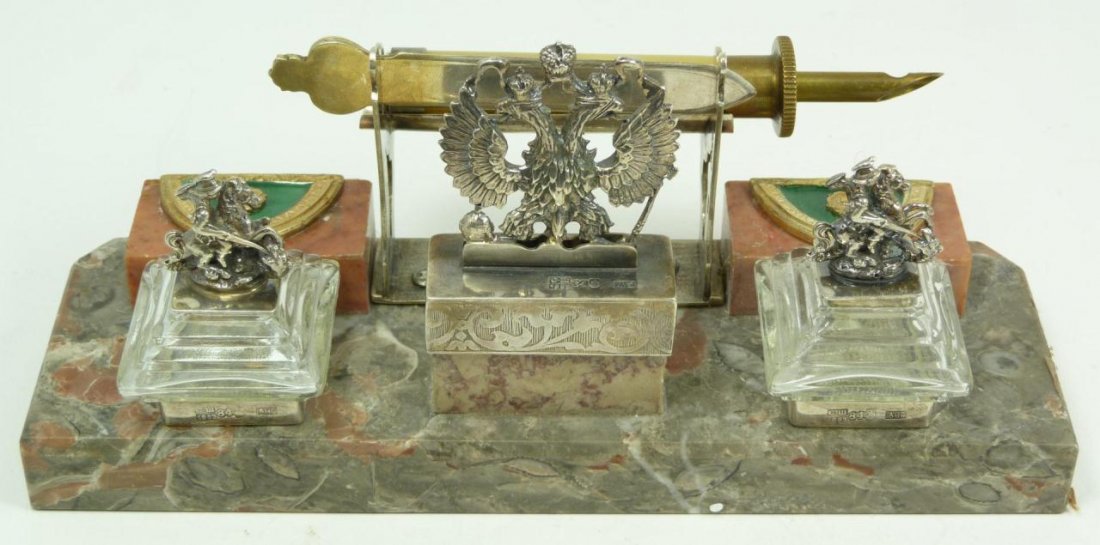 RUSSIAN SILVER ENAMEL AND MARBLE INKWELL DESK SET: Russian silver inkwell having double headed eagle coat of arms design to center. Flanked by crystal inkwells having figural St. George and the dragon covers. Front center has silver post holding ename