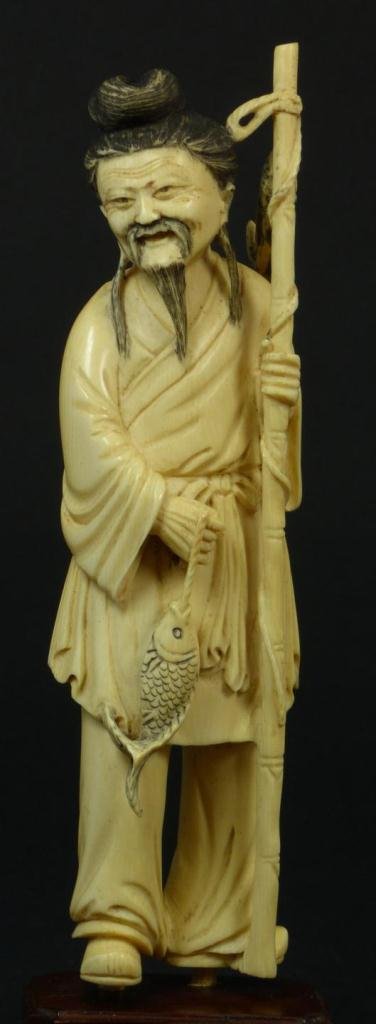ANTIQUE CHINESE IVORY CARVED FISHERMAN FIGURE: Chinese antique hand carved ivory fisherman. He is depicted with fish in hand to front and bamboo fishing pole with fish to left hand. Mounted to wooden base. 19th century. Measures 6 1/4" height + 3/