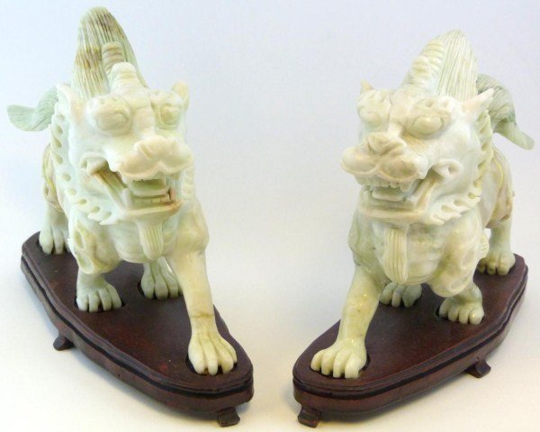 PAIR OF ANTIQUE CHINESE JADE KYRIN FIGURES: Pair of antique Chinese hand carved white jade Kyrin beast figures. Has white and green jade throughout. Includes fitted wooden base. 19th century. Measures 7 1/4" height + 1" (18.4cm x 2.5cm).