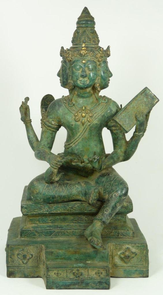 THAI BRONZE SEATED MULTI-HEADED GOD BRONZE: Antique bronze multi-headed god with green patina seated on platform throne. He is depicted holding various items. 18th/19th century. Measures 16 1/2" height x 9" width x 8" depth (41.9cm x 22.8cm x 2
