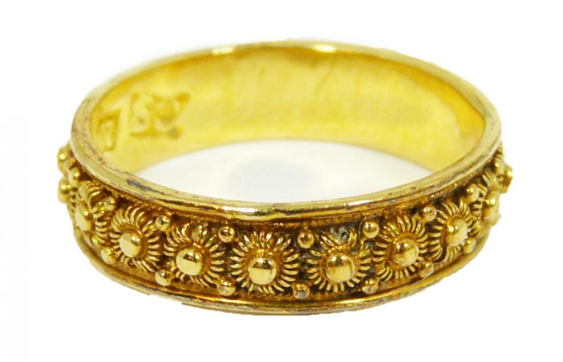 CHINESE 20K YELLOW GOLD ETERNITY RING: Chinese 20 karat yellow gold eternity ring with a beaded floral design on exterior. Stackable. Interior marked '20' and Chinese calligraphy marks. Ring size 5.