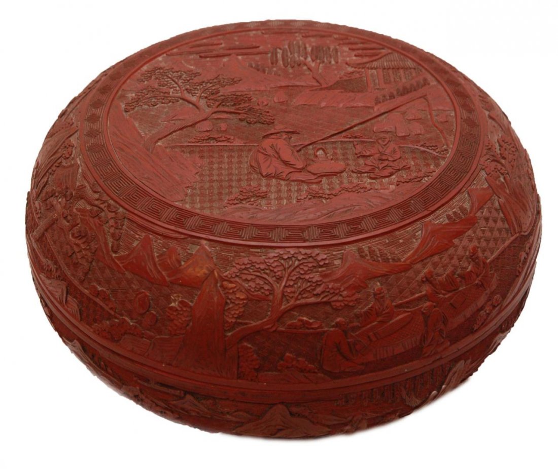 19th C CHINESE CINNABAR ROUND COVERED BOX: Antique Chinese red lacquered cinnabar round covered box. Has relief design throughout depicting landscape scenes with fishermen, attendants and wisemen playing instruments & games of Go. Intricate di