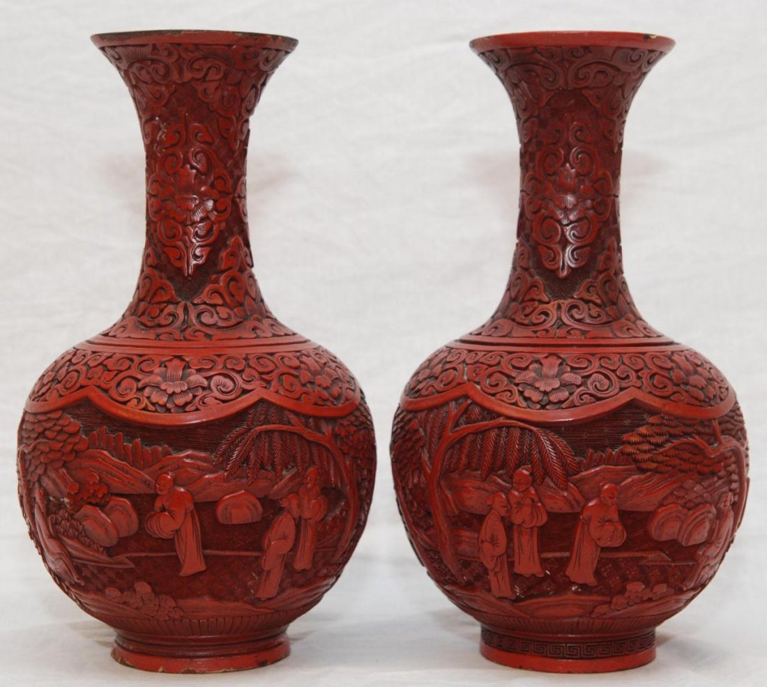 PAIR OF 19th CENTURY CHINESE CINNABAR VASES: Pair of antique Chinese cinnabar vases with intricate reticulated designs throughout. Bodies have landscape scene with wisemen and attendants. Also in the scene are trees and rock formations completed