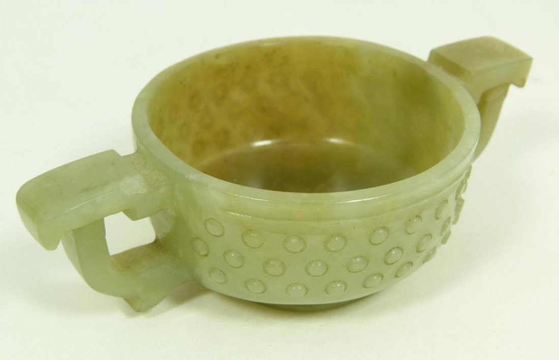 CHINESE TRANSLUCENT CARVED JADE WEDDING CUP: Chinese hand carved translucent jade handled wedding cup. beaded rice pattern designed exterior. Translucent mottled white, pale green to russet jade colors. 19th/20th Century. Measures 1 1/4 height (