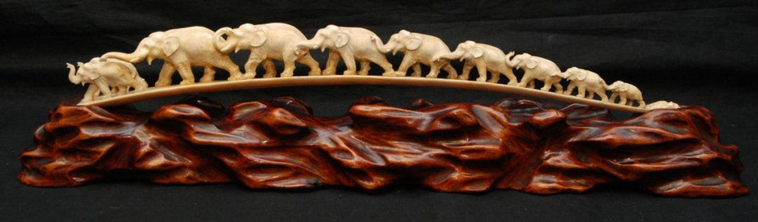 19th C HAND CARVED IVORY ELEPHANT BRIDGE ON BASE: Antique Chinese hand carved ivory figural elephant bridge. Each elephant graduating in size with trunks up. Two small elephants at the front of the line. Mid to late Qing dynasty. Includes fitted wood