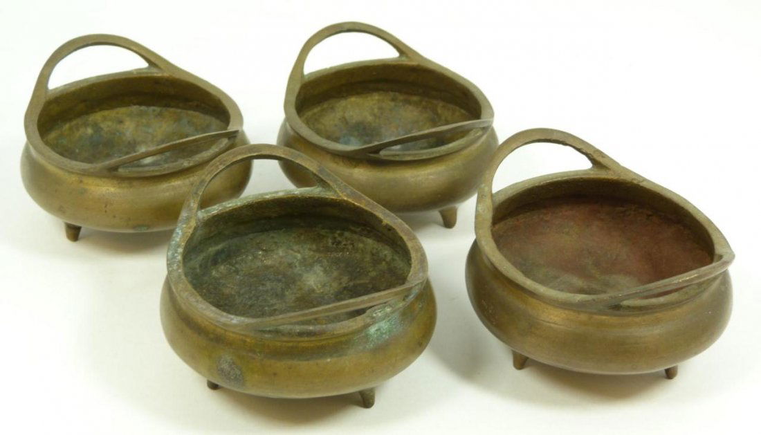 4 CHINESE BRASS LOW BOWLS W/ MING MARKS: Lot of 4 Chinese Ming Dynasty style brass low handled and tripod footed bowls. Bottoms Xuande reign marks, but made Qing to Republic Period. Each measures approx. 2 inch height (5.1 cm) x 3 3/8 inch w