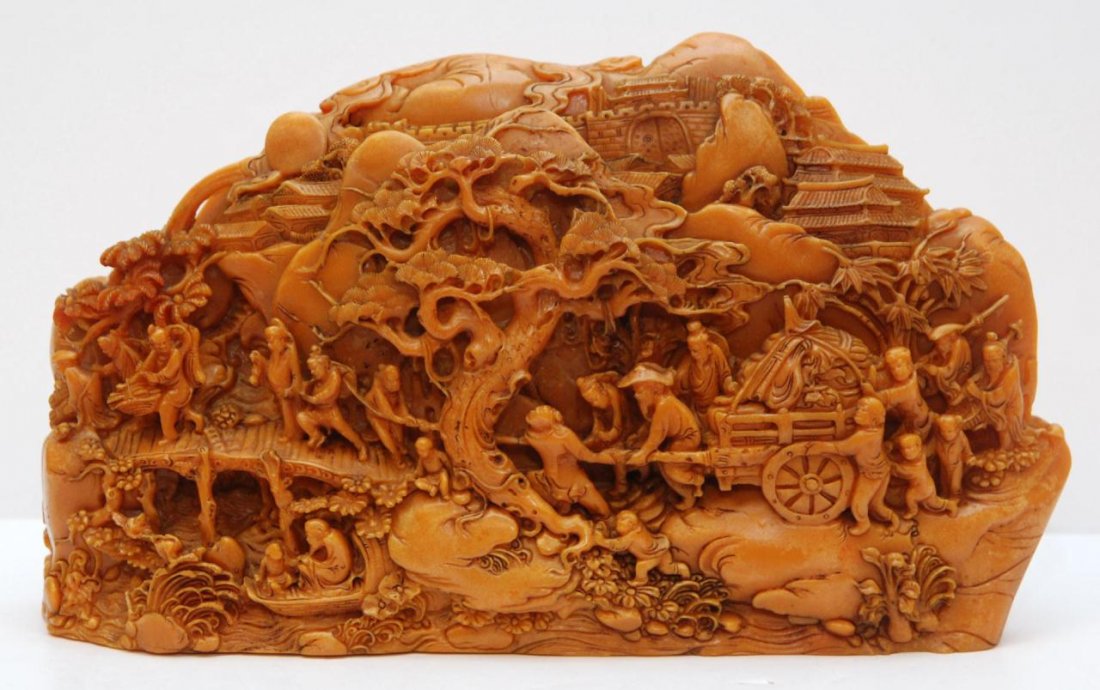 20th C CHINESE CARVED SHOUSHAN BOULDER: Antique Chinese relief carved shoushan boulder. Depicts a merchant caravan scene with numerous men and attendants pulling a heavy cart. A river can be seen with a man on boat. In the distance rock for