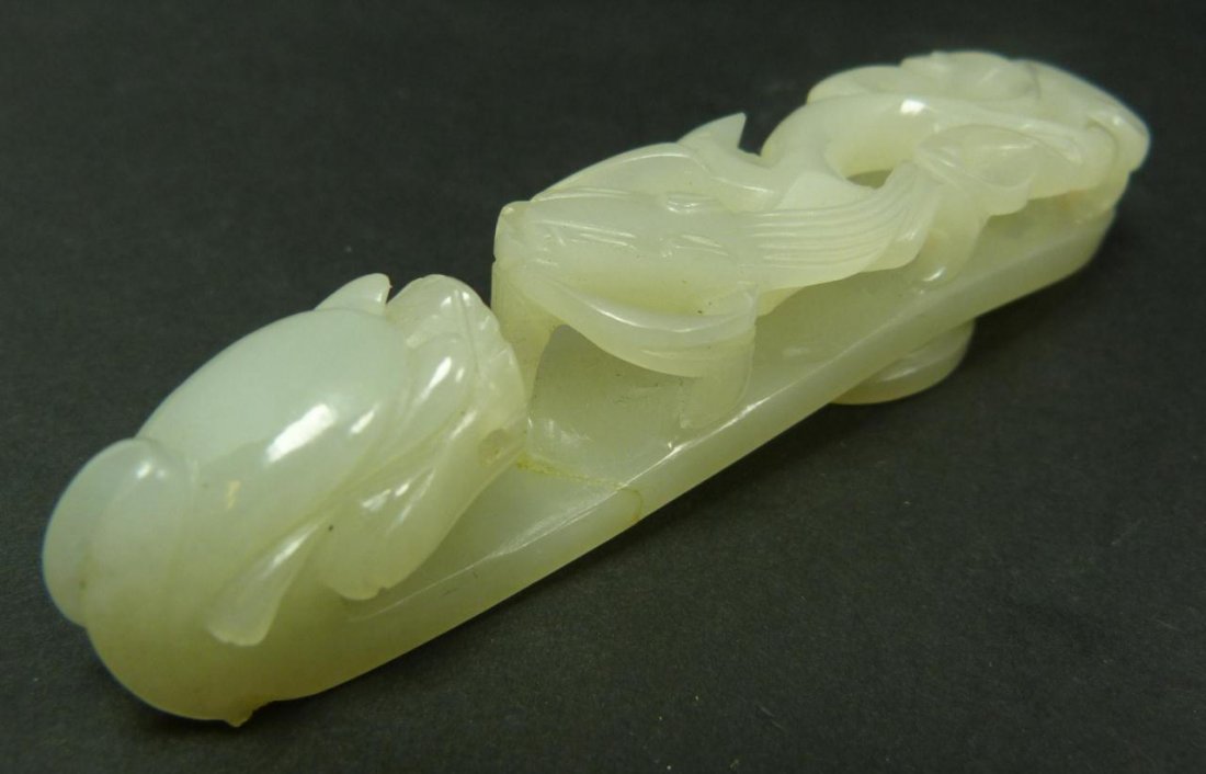 CHINESE CARVED JADE DRAGON GARMENT HOOK: A Chinese hand carved white jade Chih Lung dragon ruyi scepter garment hook. Exquisite glassy translucent even toned white jade. Measures 3 3/4" length (9.5cm). Total weight of 40 grams.